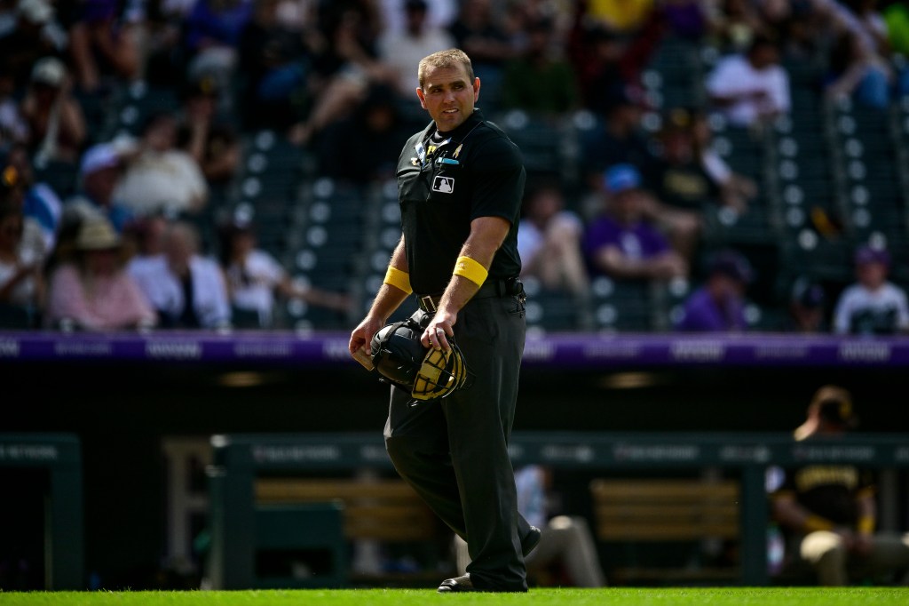 Umpire Brock Ballou looks on while wearing yellow armbands to recognize Childhood Cancer Awareness Day during a game between the Colorado Rockies and the San Diego Padres at Coors Field on September 7, 2025 in Denver, Colorado.