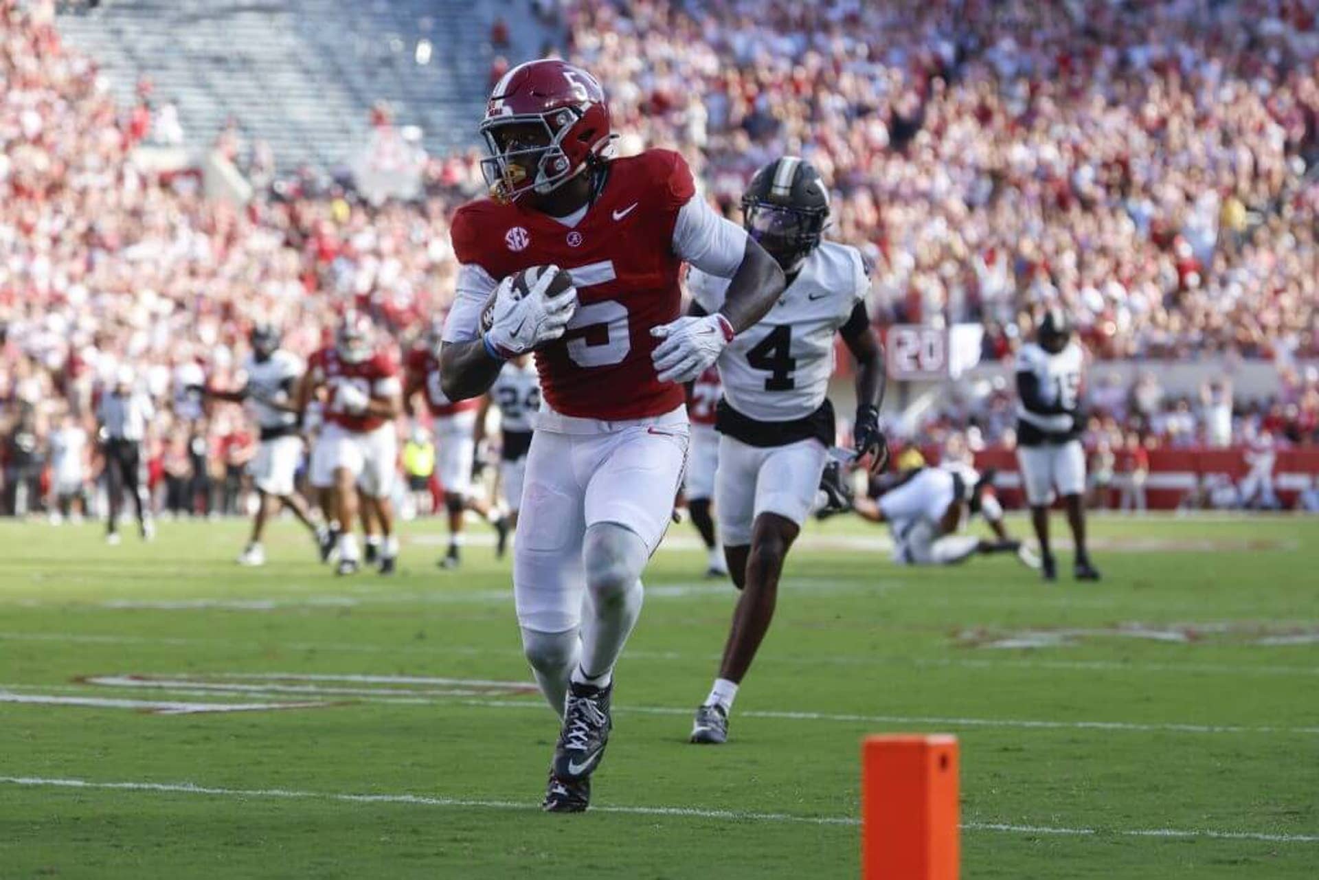 Germie Bernard carries the ball toward the corner of the end zone with a Vanderbilt defender trailing behind him.