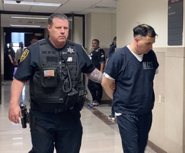 Miguel Guzman-Pardo is escorted by a deputy sheriff from a Montgomery County courtroom to begin prison term. (Photo by Carl Hessler Jr. - MediaNews Group)