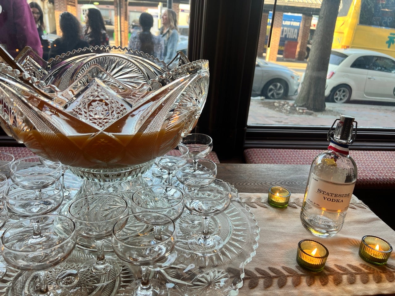 A crystal punch bowl filled with punch surrounded by glasses at The Cacoa Pod event space in Philadelphia's Old City neighborhood.
