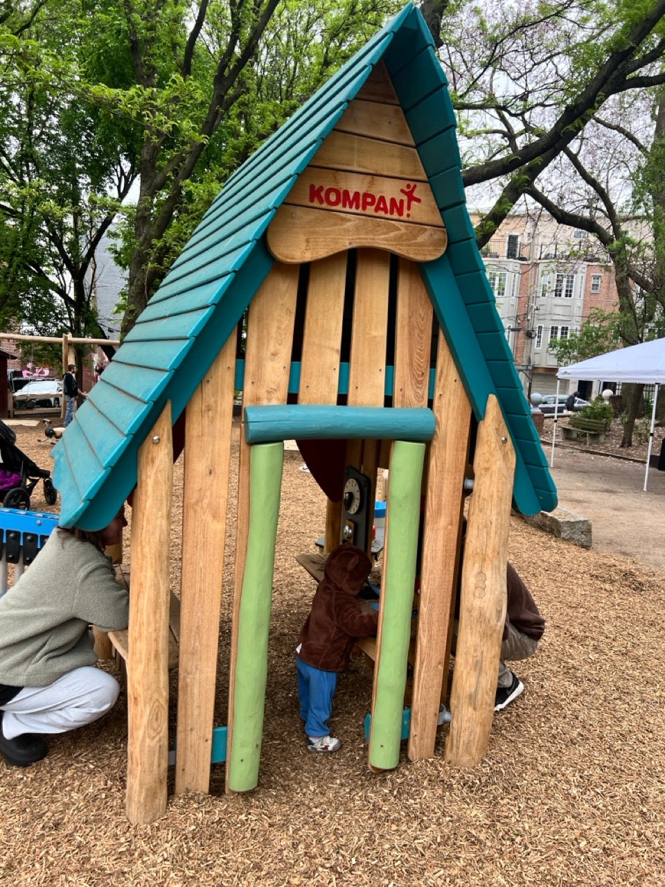 Liberty Lands playground in Northern Liberties in Philly is brand new with all wood structures and some really cute features including this small wood playhouse with a blue roof.