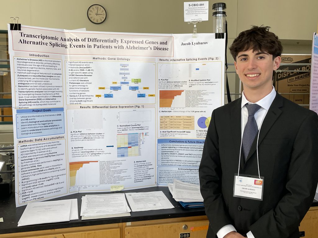 person in suit and tie standing in front of poster board