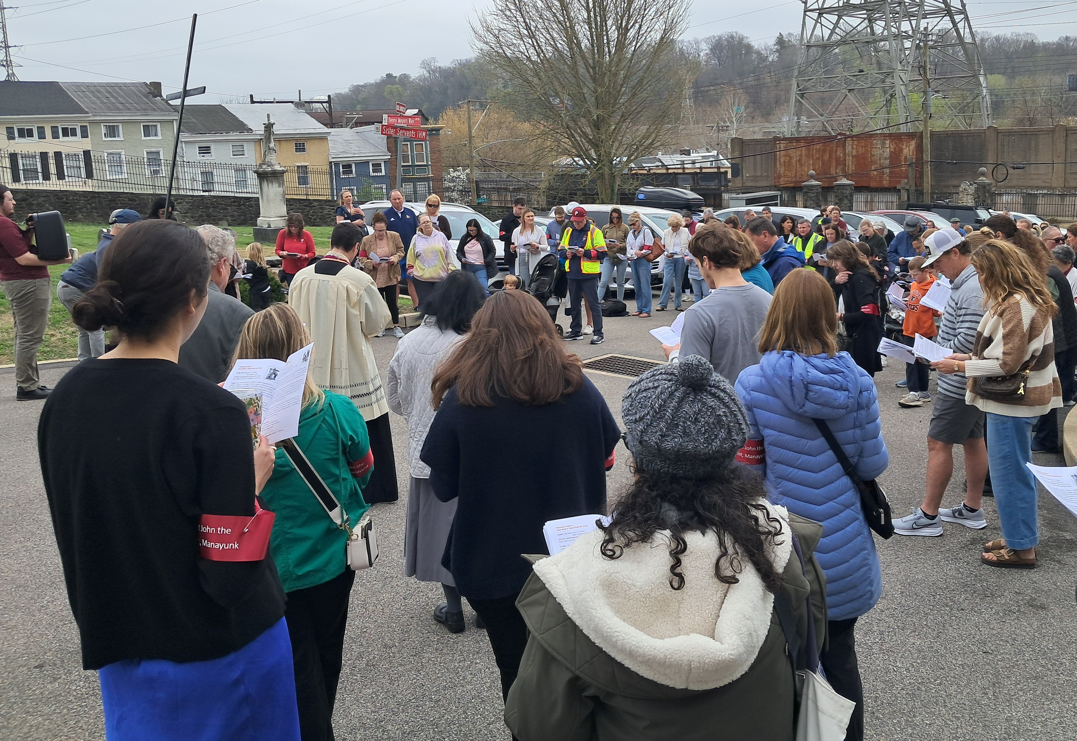 Attendees gather in the St. John the Baptist parking lot...