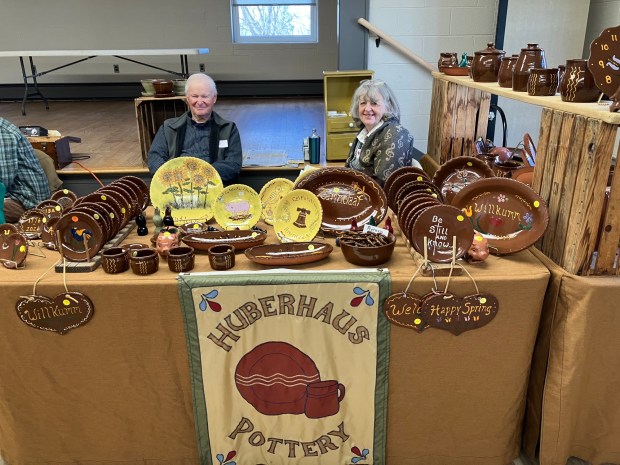 John Huber, left, of Huberhaus Pottery in Myerstown displayed his PA Dutch redware pottery with traditional patterns during the 14th annual Zammelaaf at the Zion UMC Church of Iona, Lebanon, March 21. (Photo courtesy of Mary Laub, Maxatawny Township)