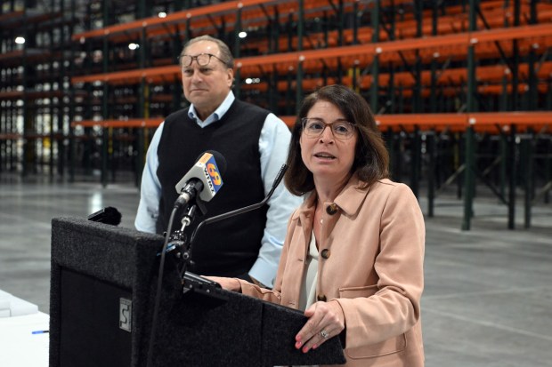 Christy Weeber, president of East Penn Manufacturing, speaks during a ribbon-cutting ceremony at the East Penn Manufacturing Corporate Distribution Center, 8697 Allentown Pike, Maidencreek Township, on Friday, April 10, 2026. Steve Wolfson, president of the Wolfson Group, is at left. (BILL UHRICH/MEDIANEWS GROUP)