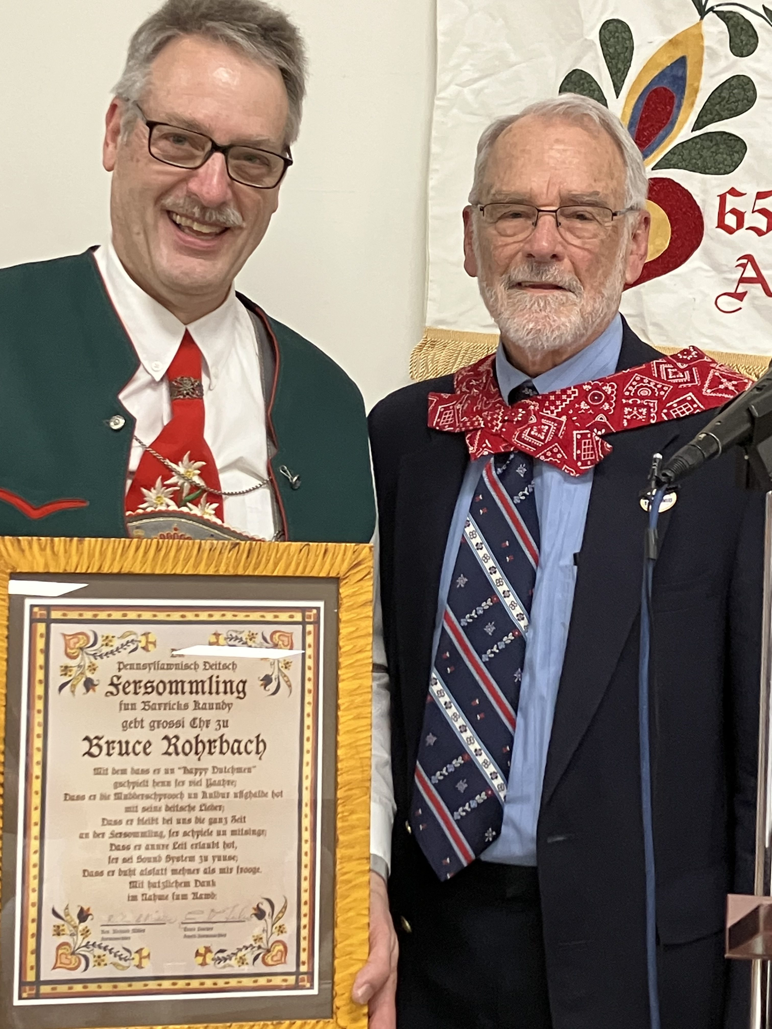 Bruce Rohrbach, left, received a certificate for his dedication to...