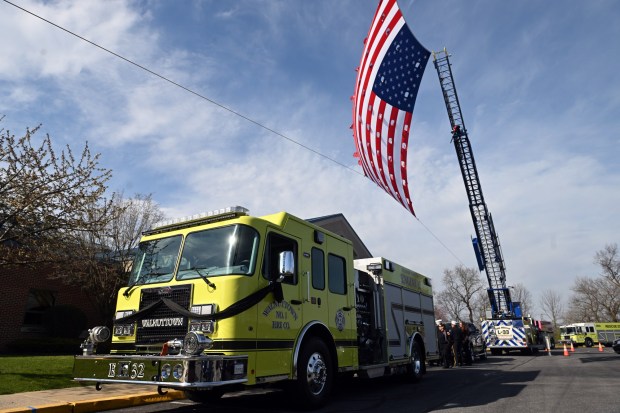 A Walnuttown fire truck is parked below the flag memorial outside Fleetwood High School prior to the viewing Friday, April 10, 2026, for Walnuttown Fire Chief Jeffory L. Buck and Assistant Chief Robert R. Shick Jr. (BILL UHRICH/READING EAGLE)