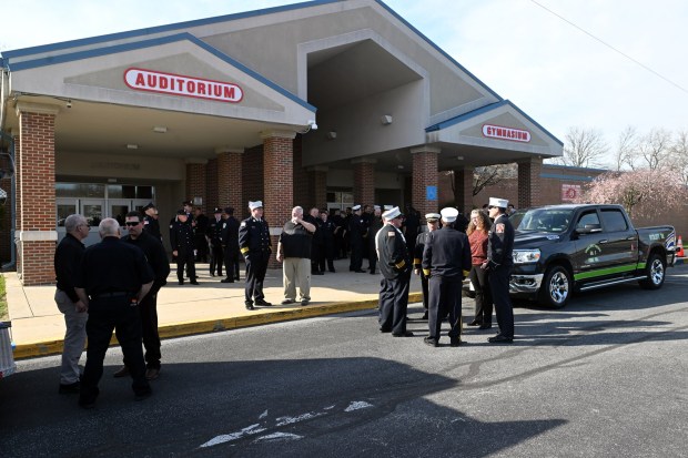 Members of area fire companies wait outside Fleetwood High School prior to the viewing Friday, April 10, 2026, for for Walnuttown Fire Chief Jeffory L. Buck and Assistant Chief Robert R. Shick Jr. (BILL UHRICH/READING EAGLE)