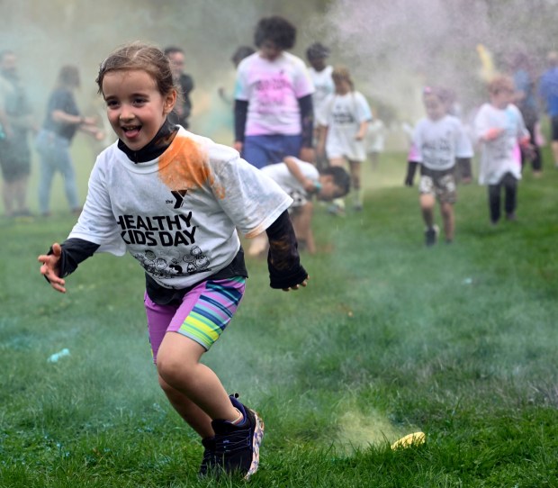 Children get splashed with color during the YMCA Color Run during Healthy Kids Day at the Berks County Heritage Center in Bern Township, which returns Saturday. (BILL UHRICH/READING EAGLE)