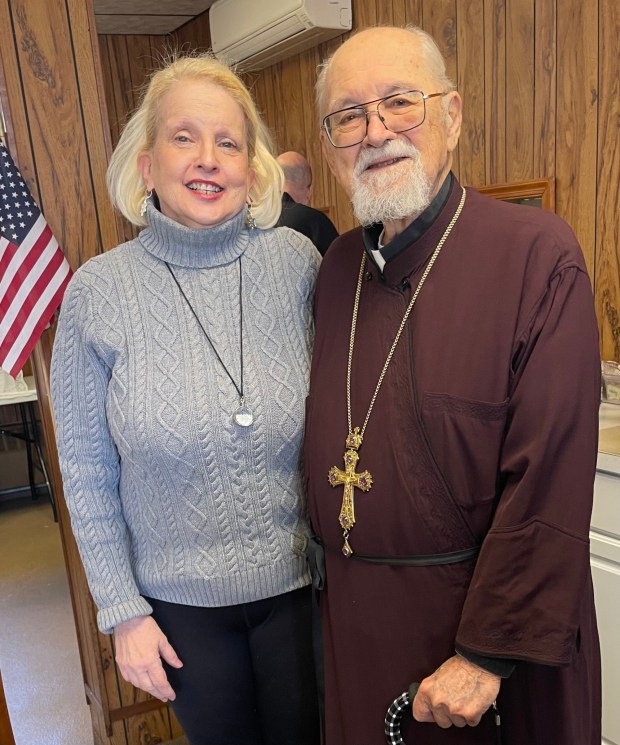 Mitred Archpriest Daniel Geeza receives congratulations from his cousin, Lauren Telep of Olyphant. (Courtesy of Lauren Telep)