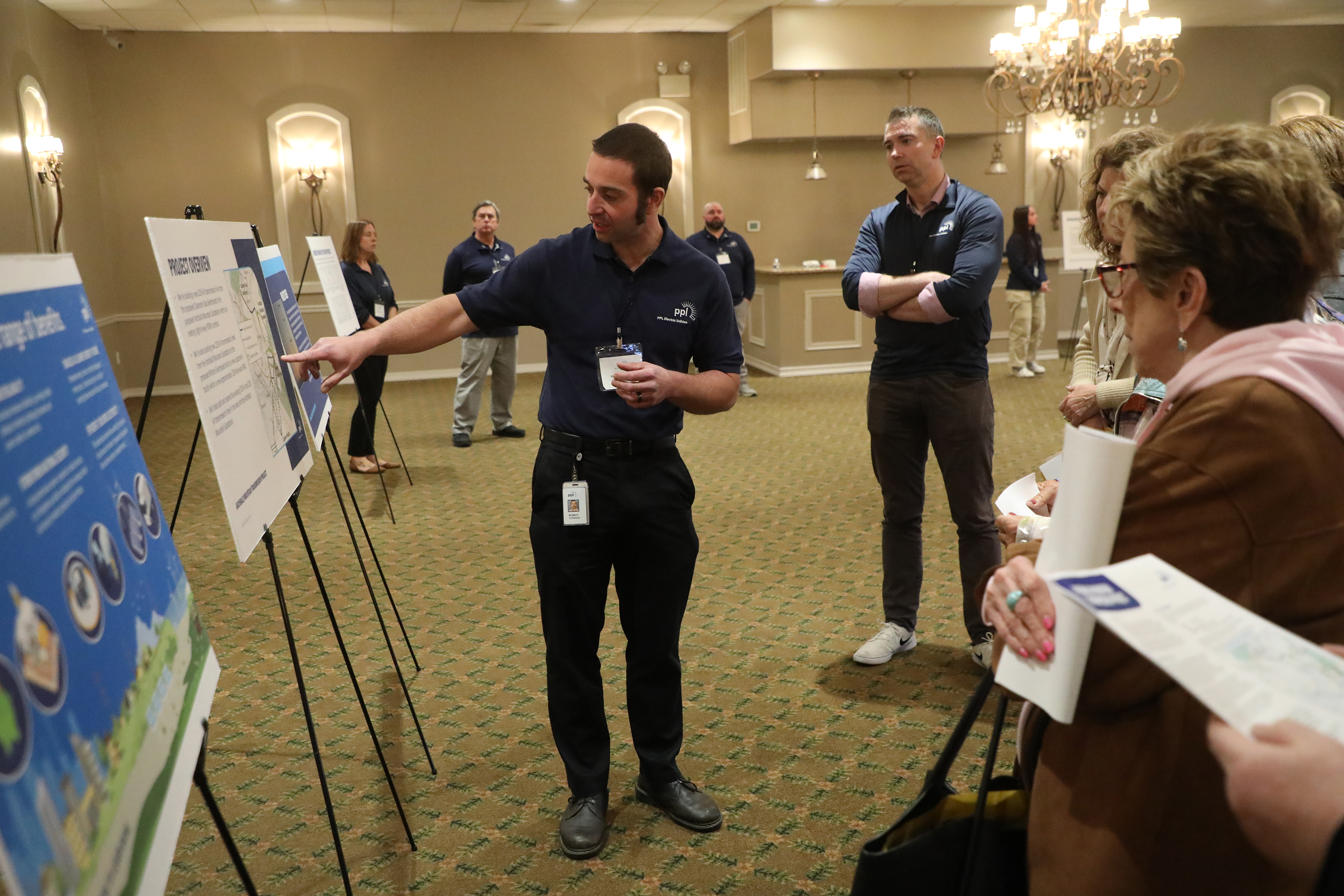 PPL representative Horst Lehmann talks to community members about the...