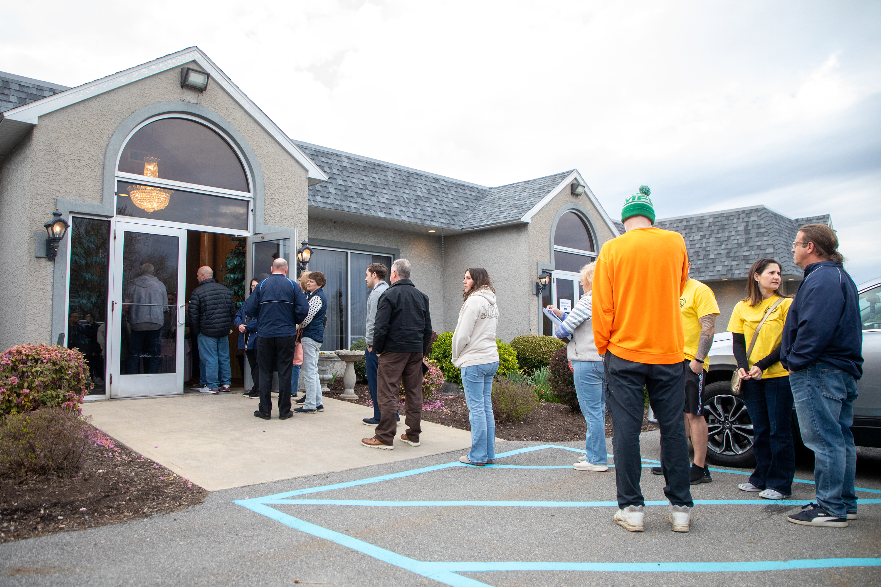 Community members line up outside to enter Montdale Country Club...