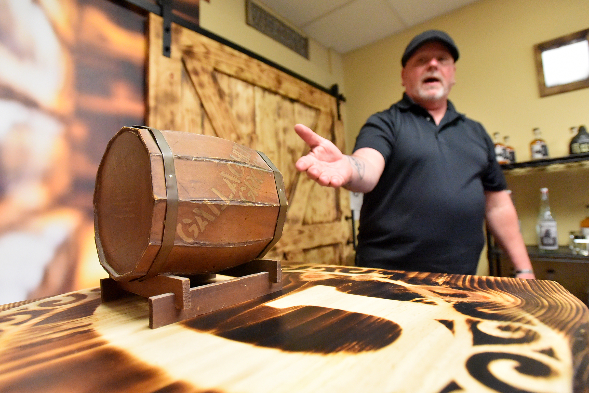 Owner of Gallagher Distillery Matthew Gallagher shows off a miniature...