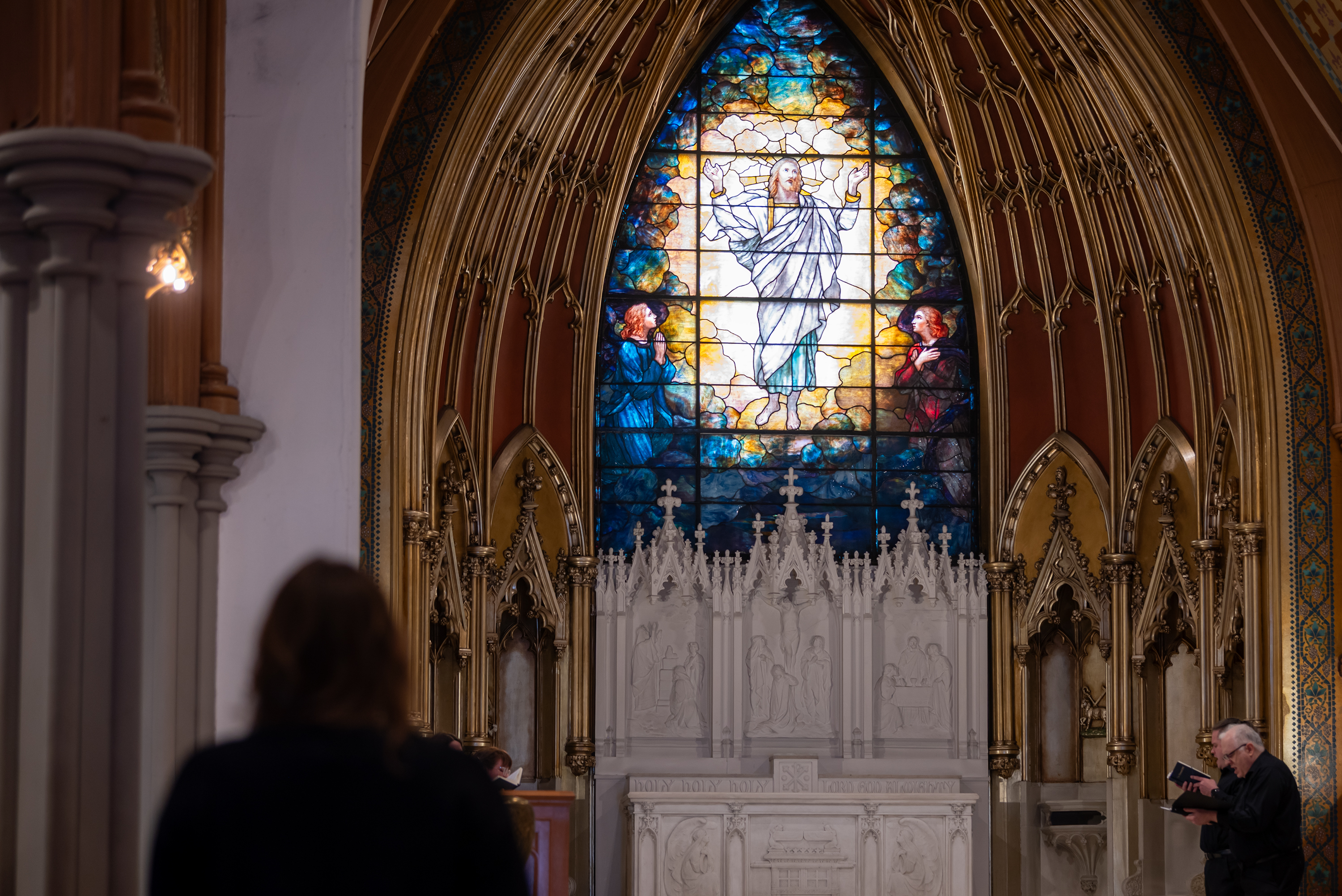 Worshipers stand to sing a hymn during Good Friday service...