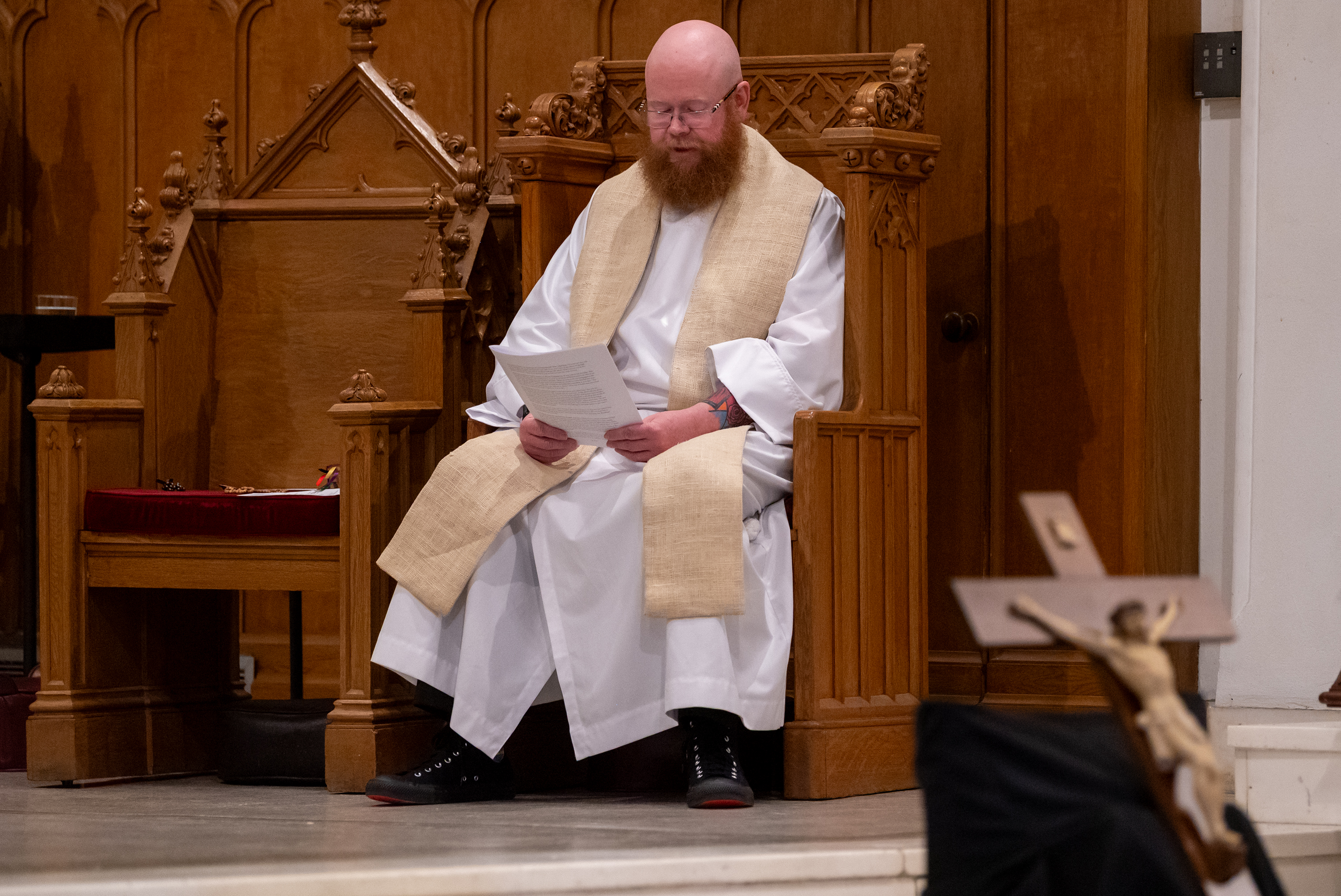 Father Tyler Parry reads the Passion of the Christ during...