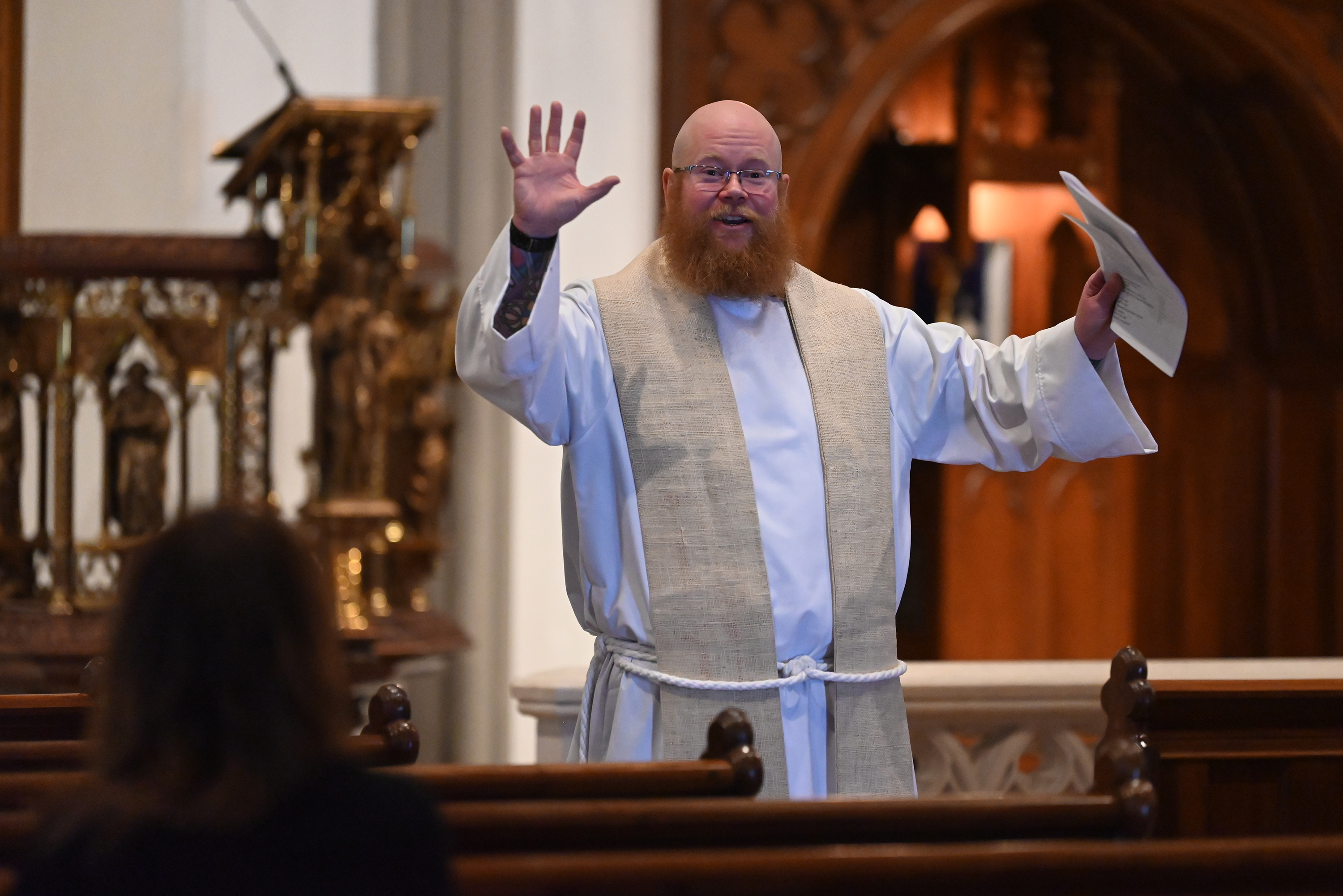 Father Tyler Parry delivers his homily during Good Friday service...