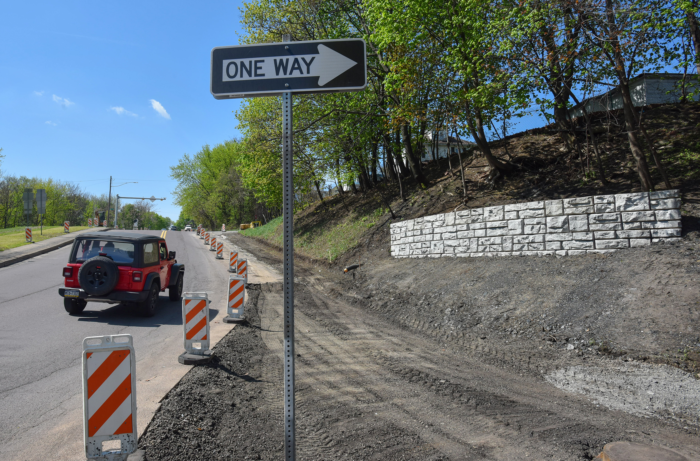 A vehicle travels past a construction zone up North Main...