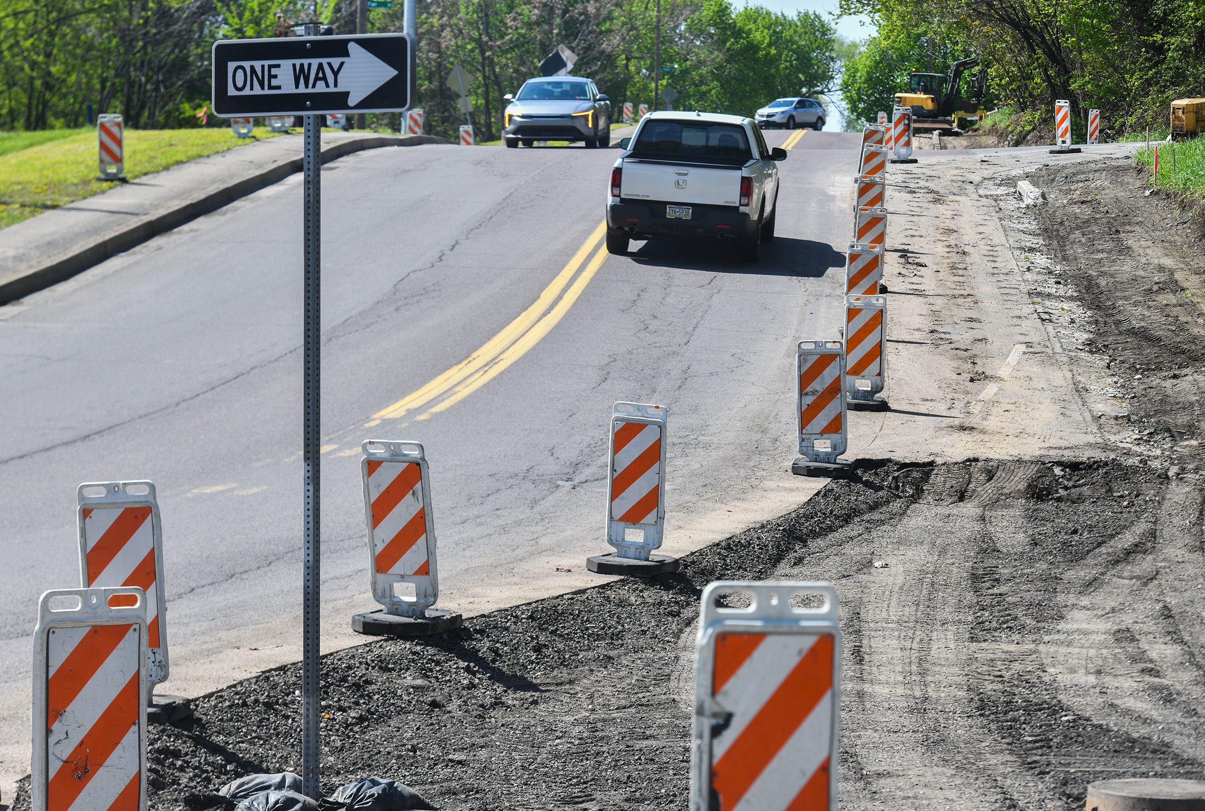 Vehicles travel on North Main Avenue past construction work in...