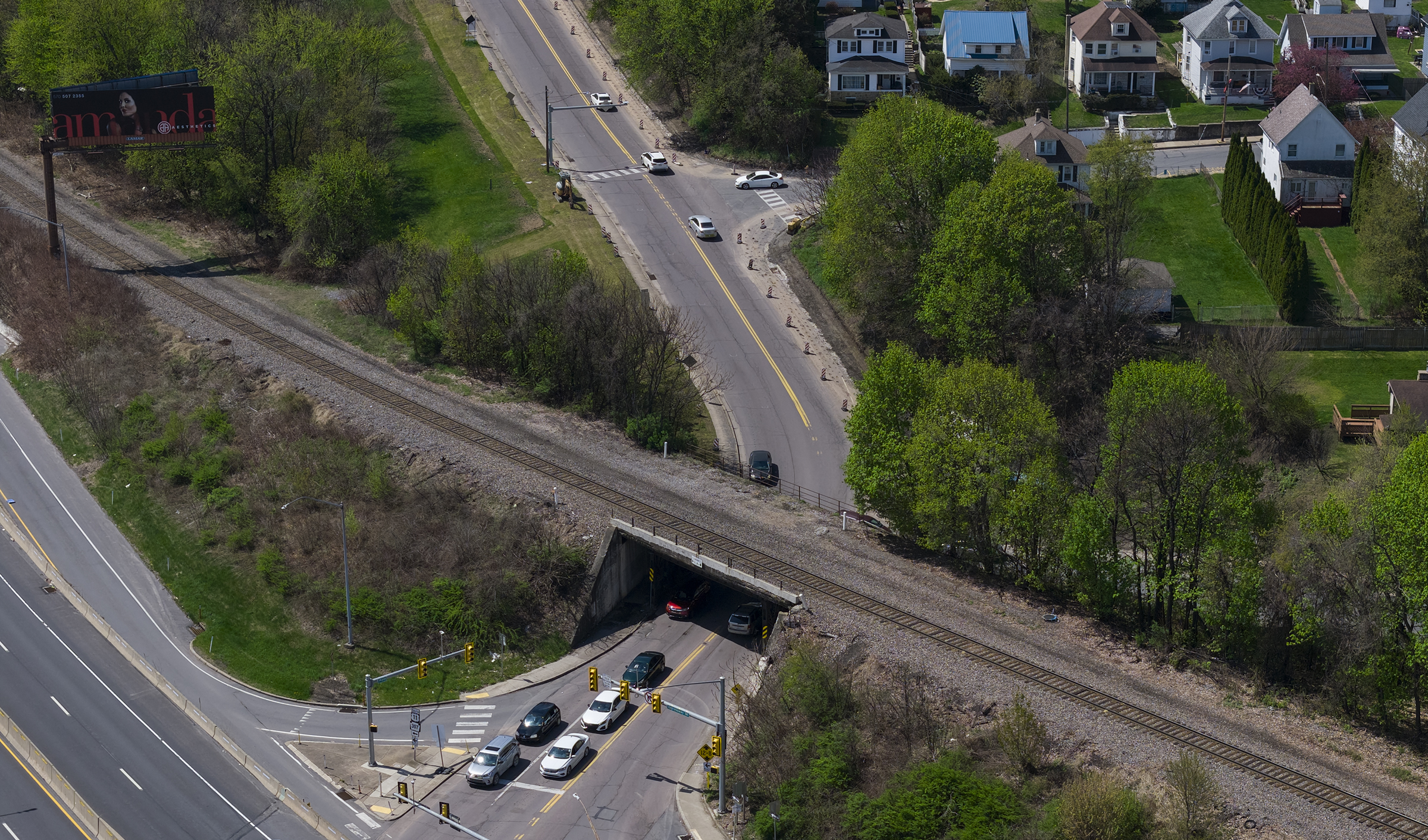 A railroad bridge crosses over North Main Avenue where a...
