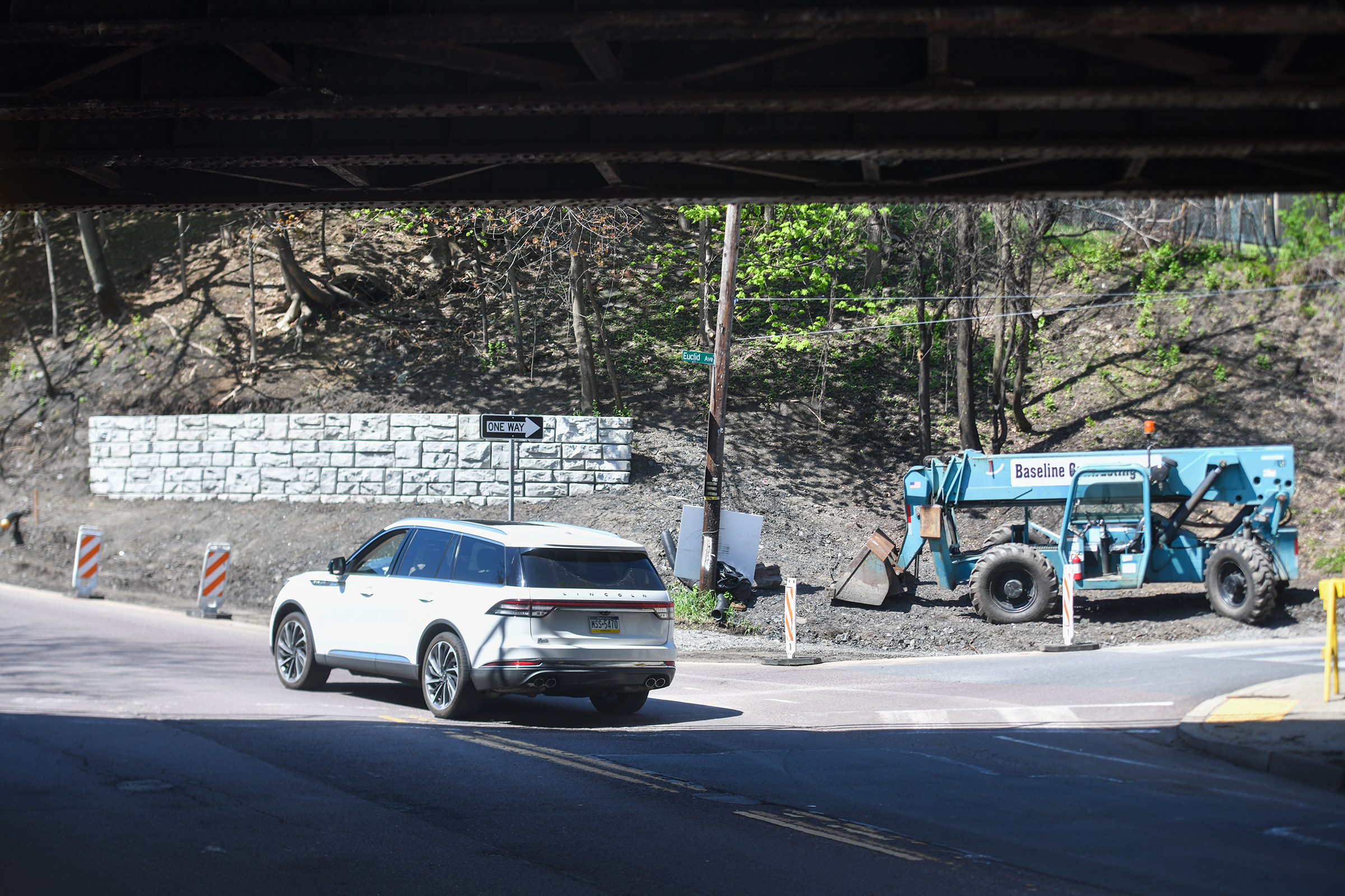 A vehicle travels underneath a railroad bridge going up North...
