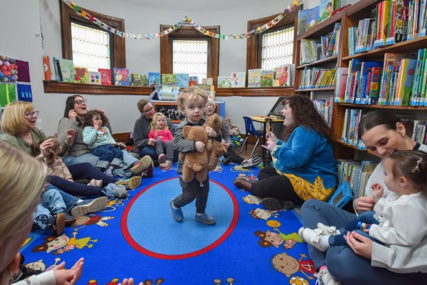 Hayes Wilson, 2, of S. Abington Twp., carries his teddy bears during the Toddlers on the Move event held to celebrate National Library Week at the Nancy Kay Holmes Branch Library in Scranton Monday, April 20, 2026. (SEAN MCKEAG / STAFF PHOTOGRAPHER)