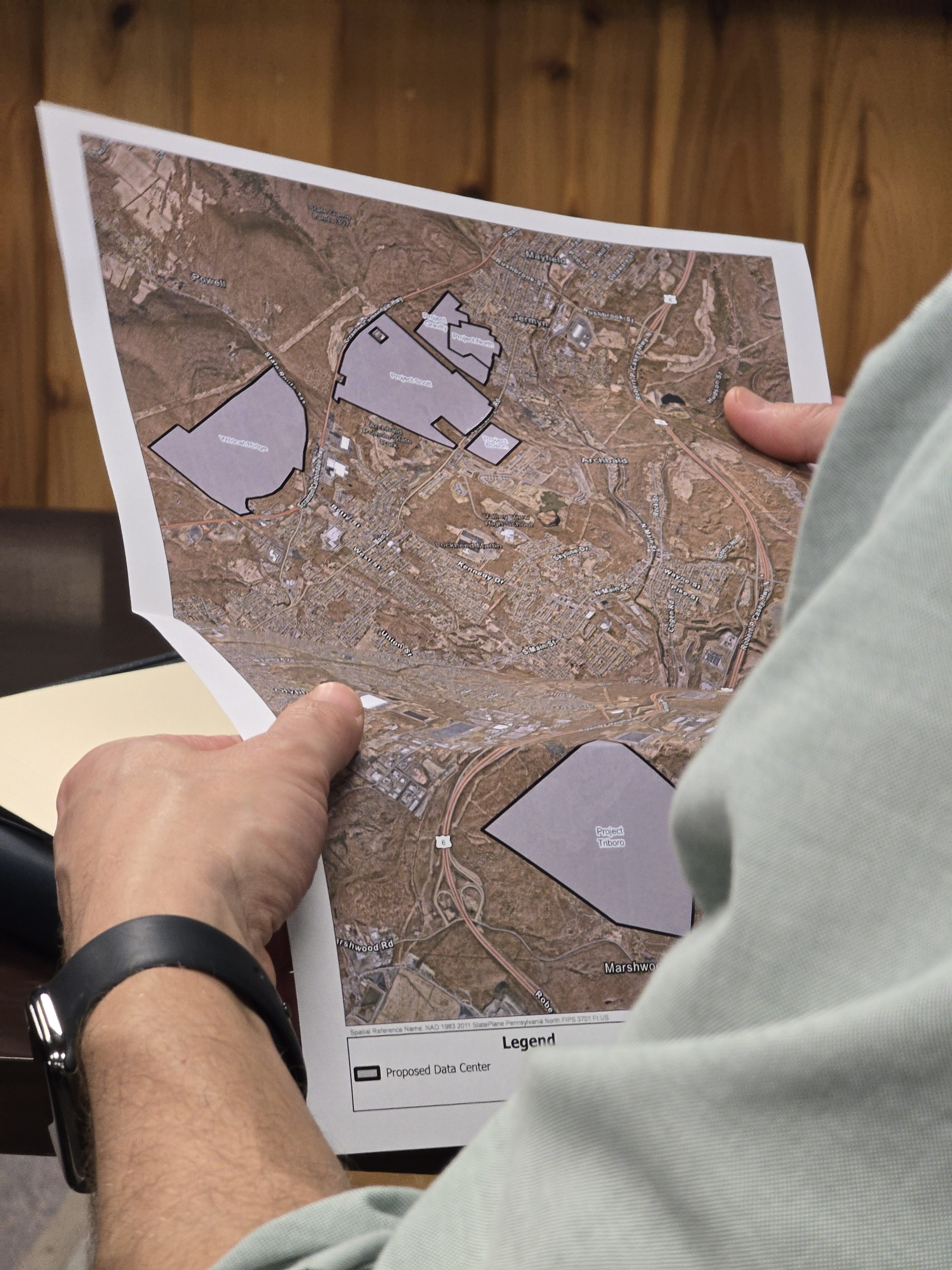 A Pennsylvania American Water employee holds a map of Midvalley...