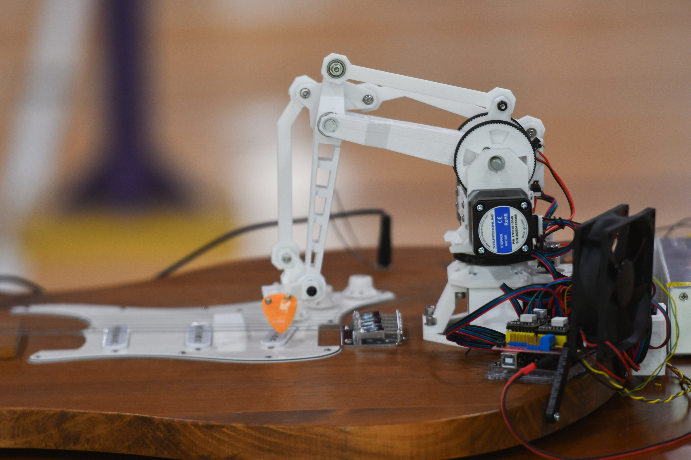 A robot strums a replica guitar at the University of...