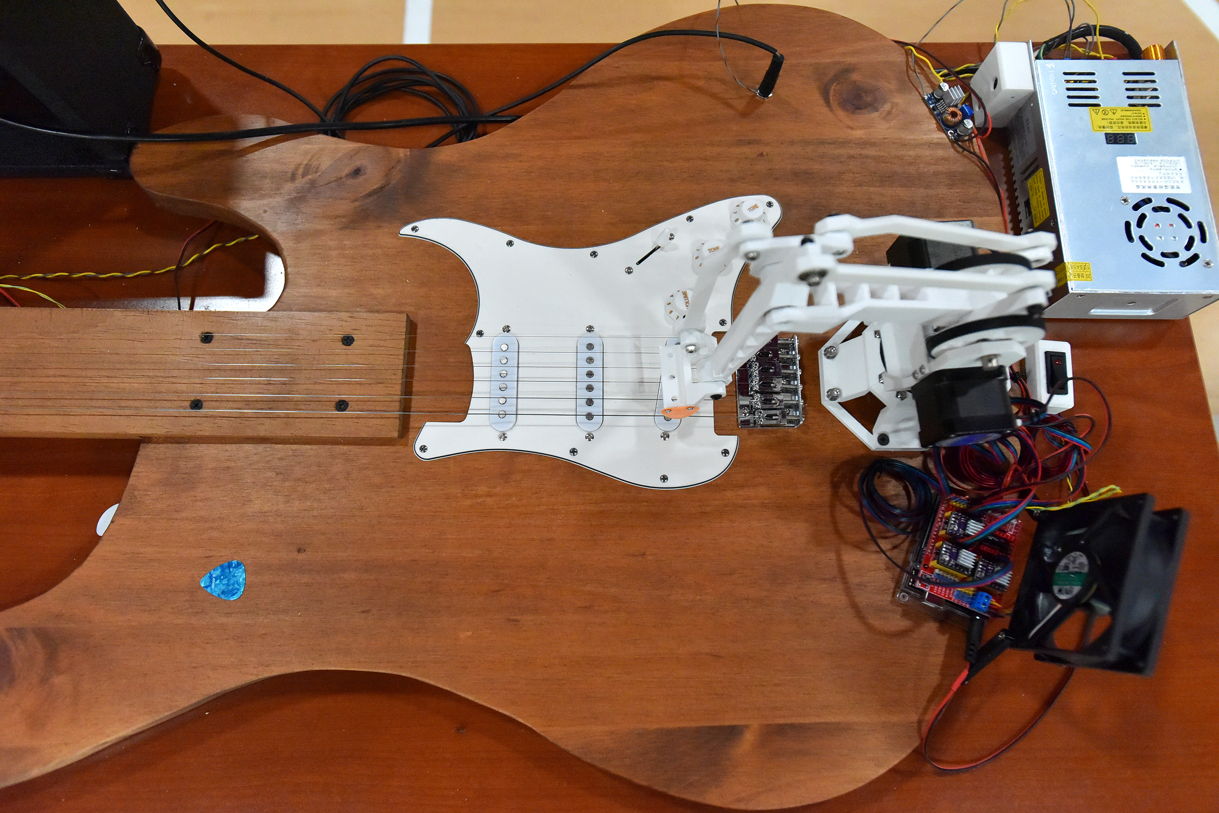 A robot strums a replica guitar at the University of...