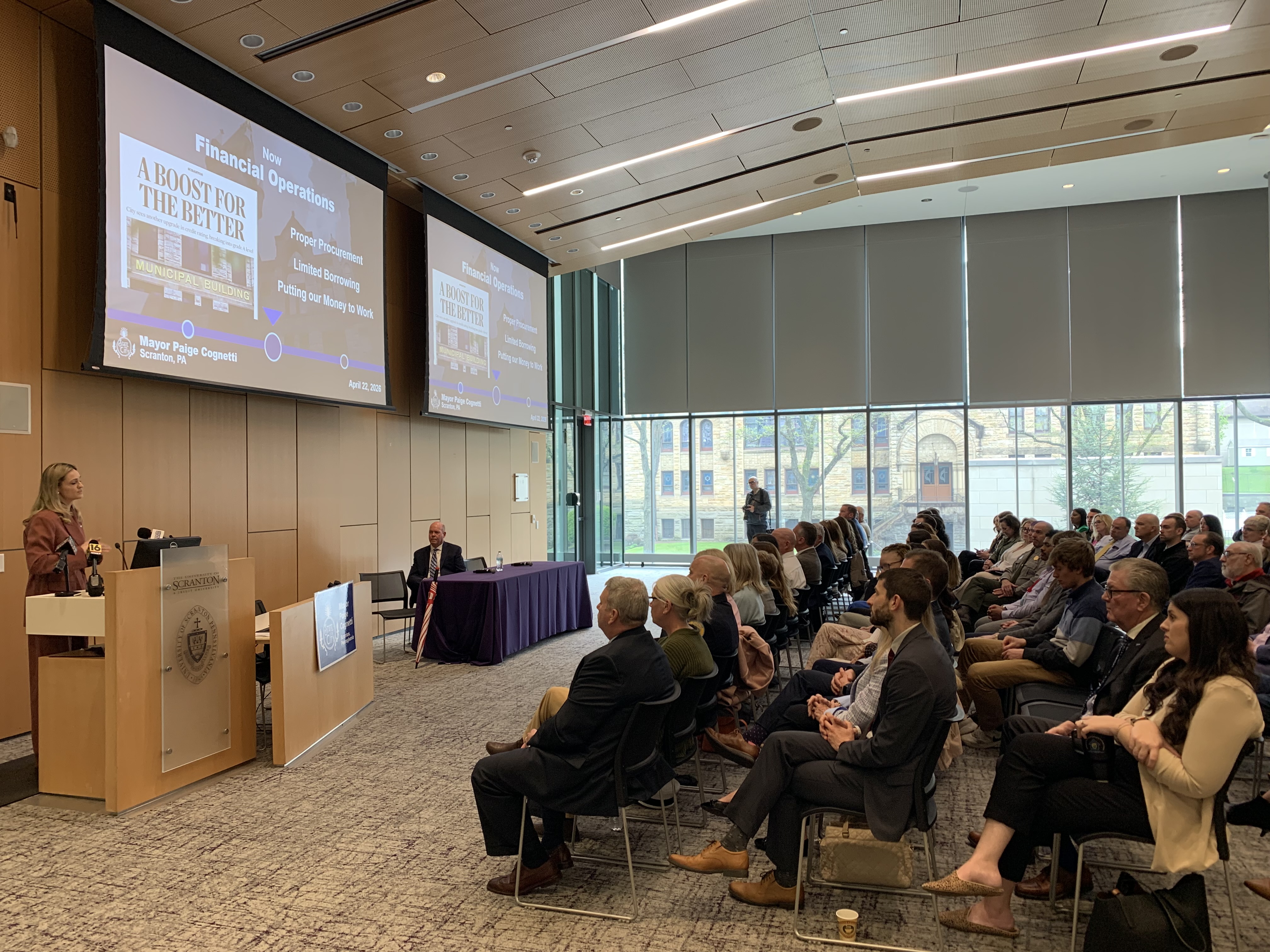 Scranton Mayor Paige Gebhardt Cognetti, at podium at left, delivers...