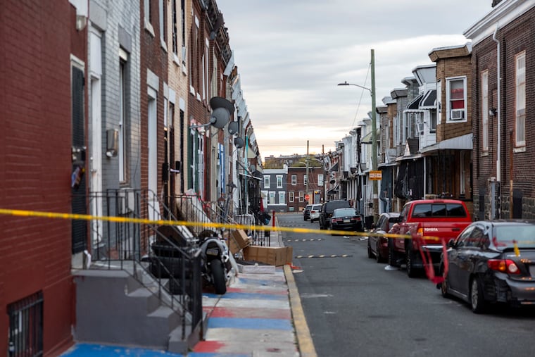 Philadelphia police officers stationed a vehicle at the location where federal agents raided Kensington’s Weymouth Street and arrested more than 30 alleged members of a drug ring last year.