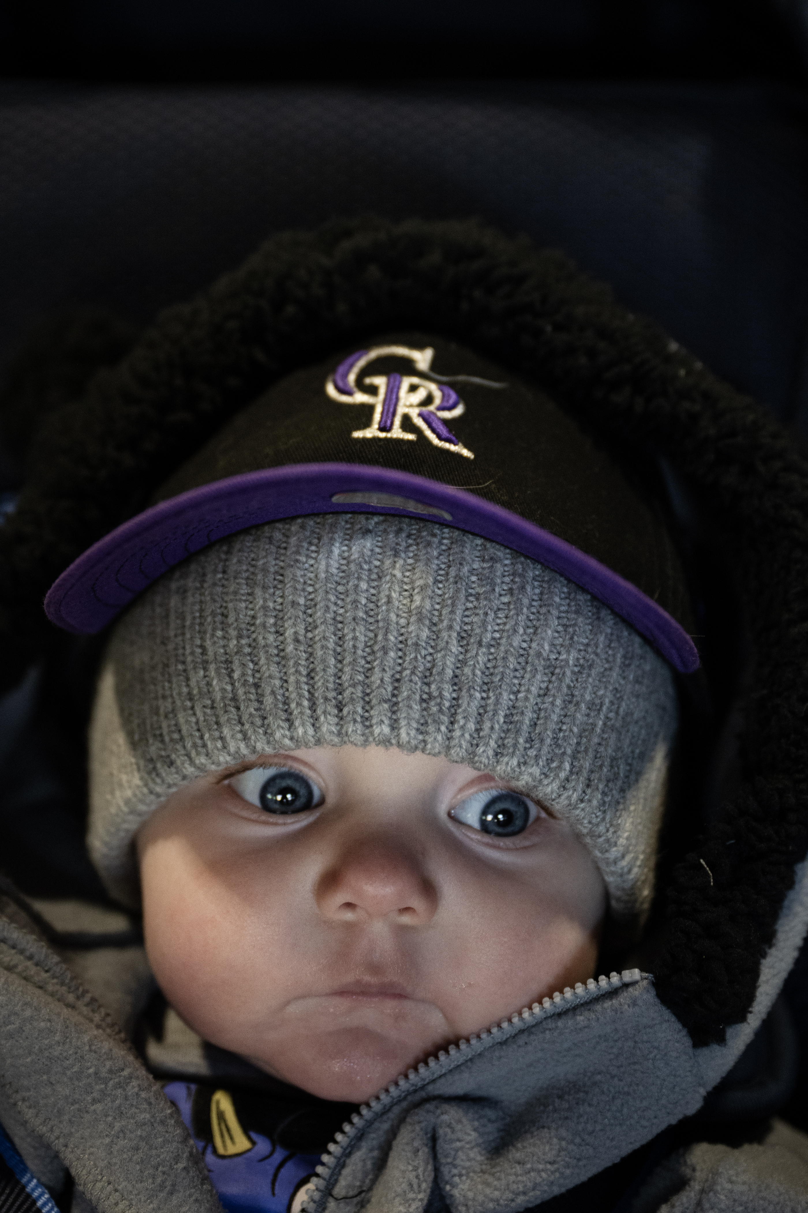 Seven-month-old Charles Snow wears a tiny Colorado Rockies hat before...