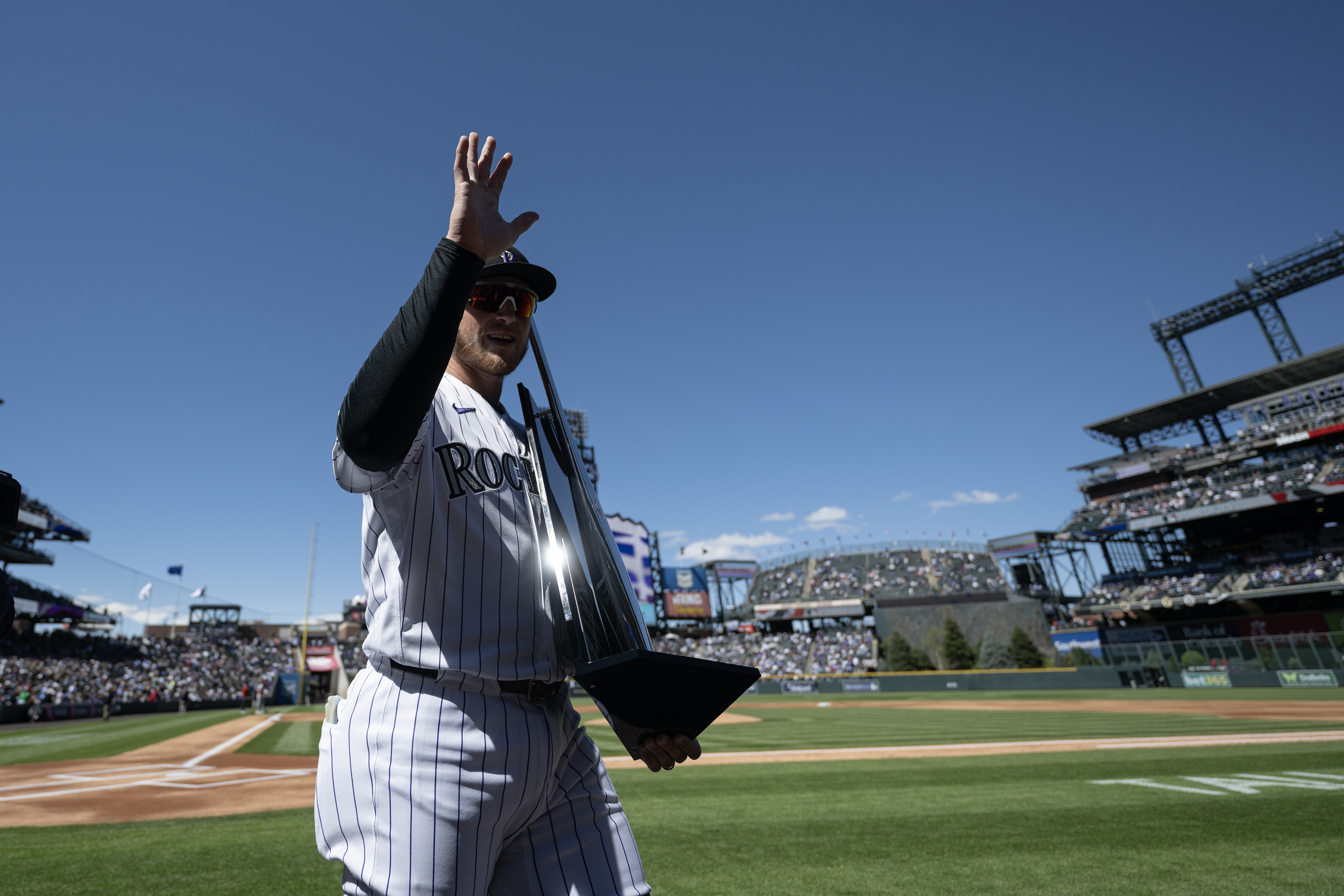 Catcher Hunter Goodman (15) of the Colorado Rockies waves to...