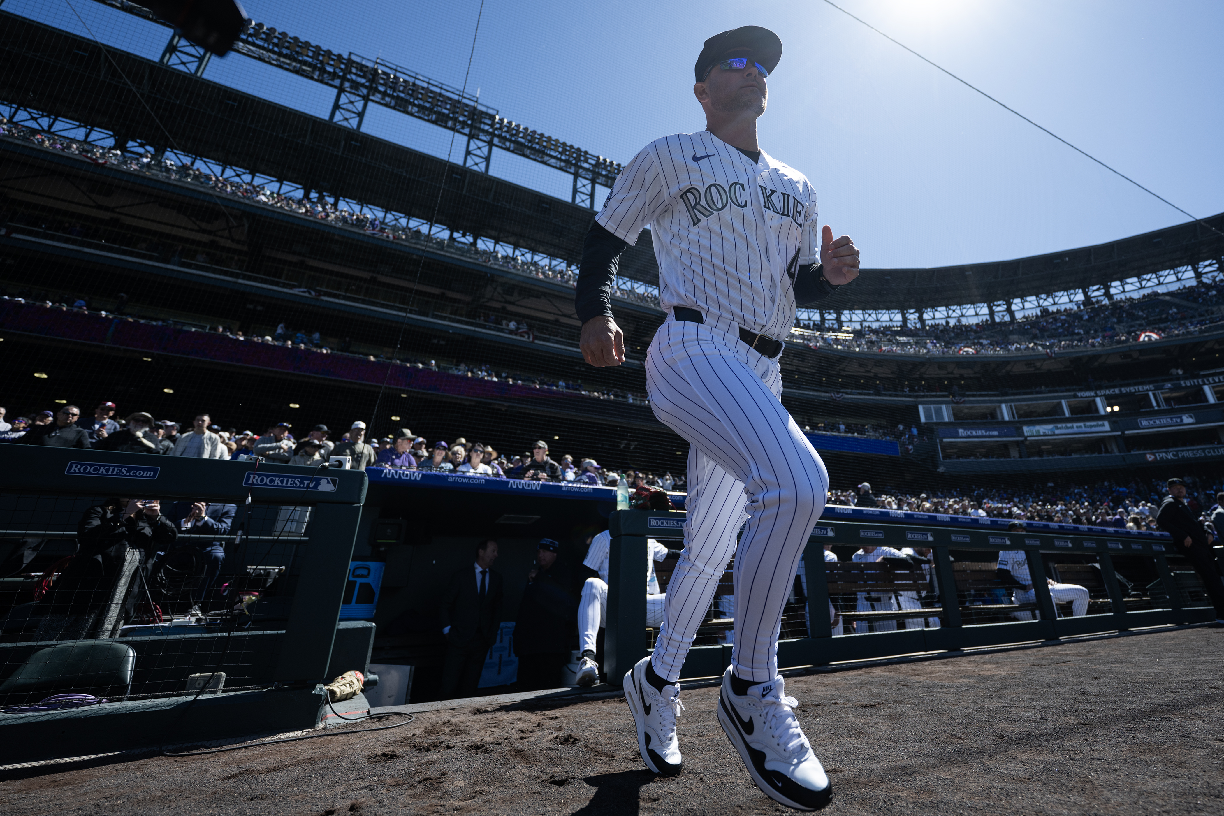 Manager Warren Schaeffer (4) of the Colorado Rockies runs onto...