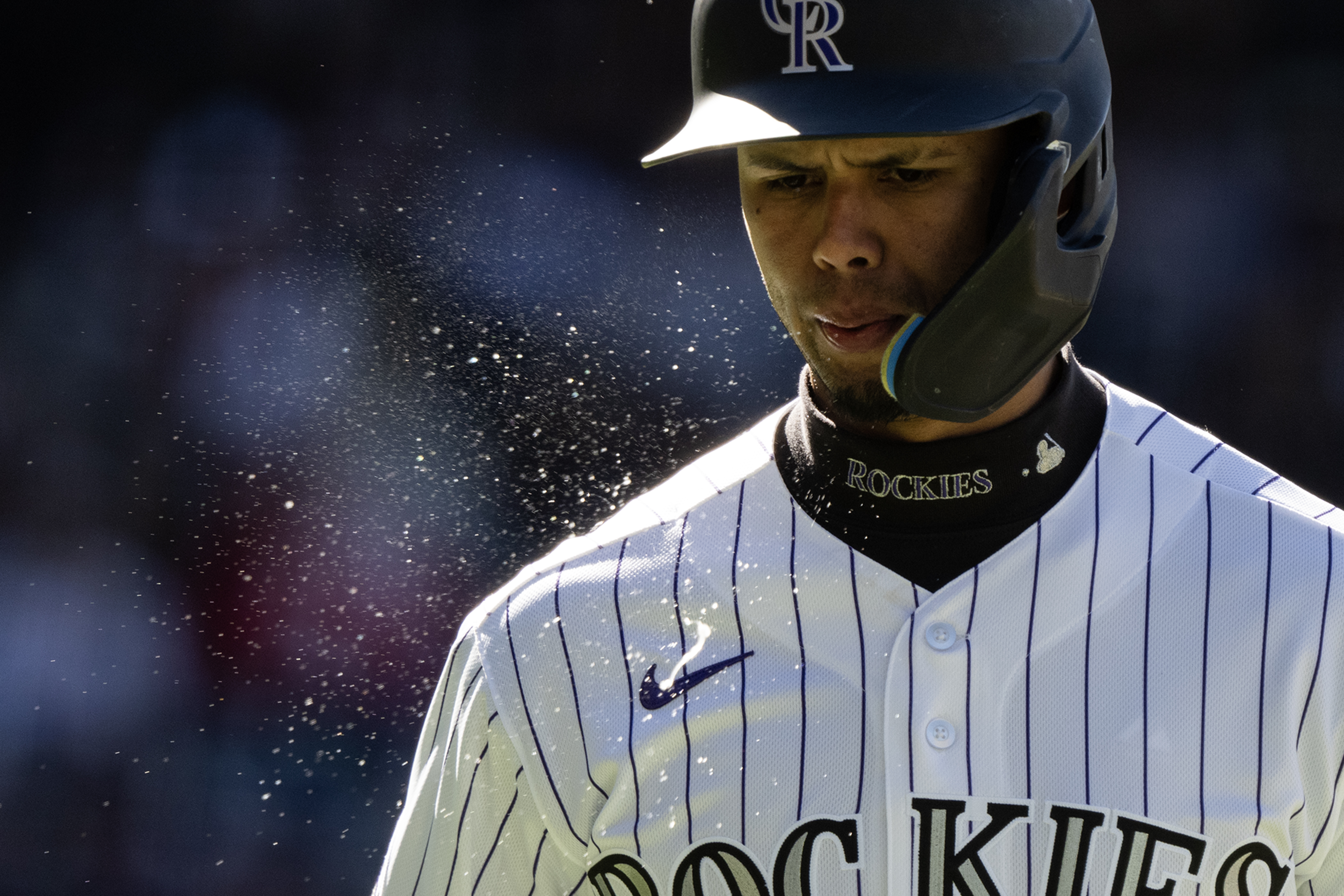 shortstop Ezequiel Tovar (14) of the Colorado Rockies spits as...
