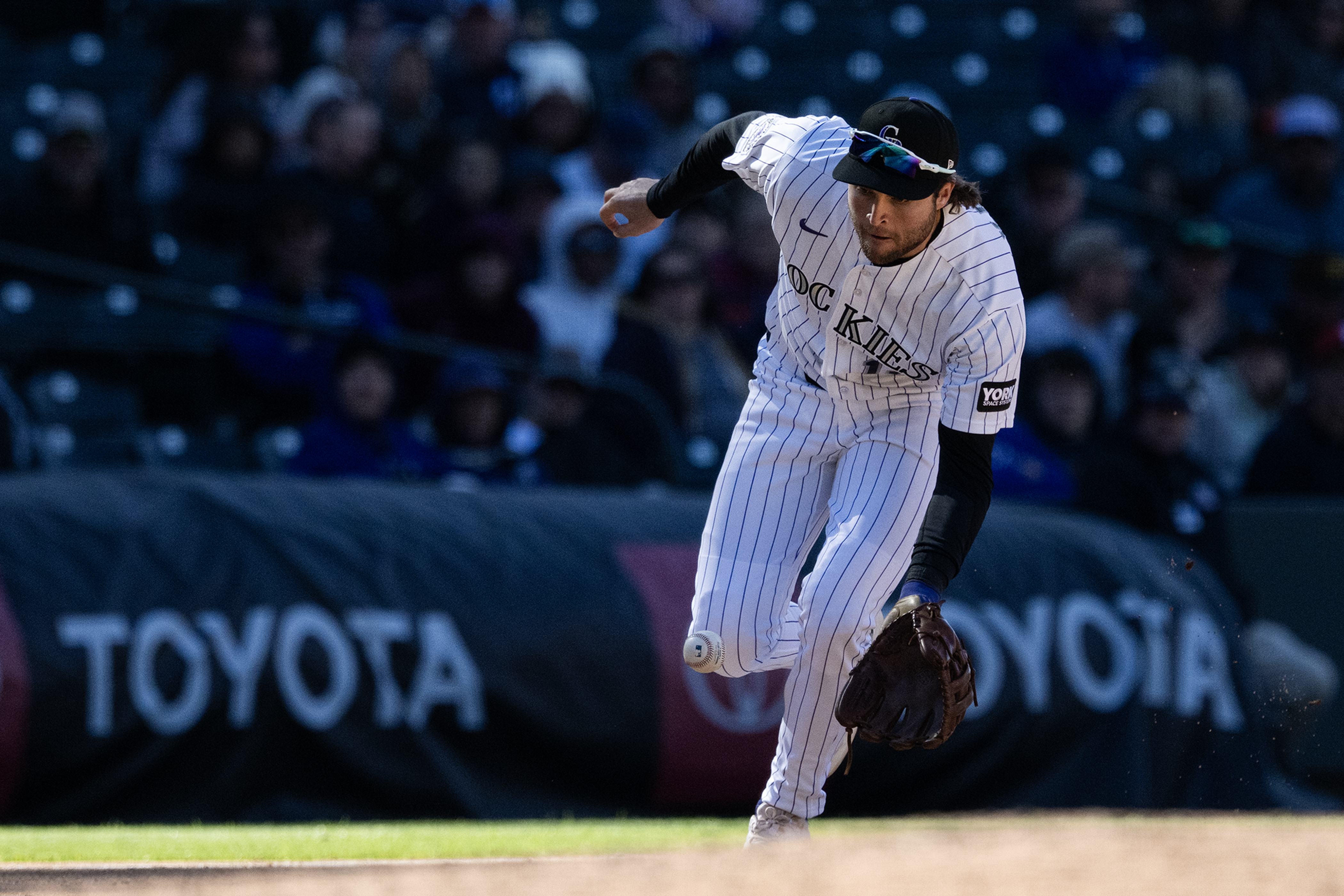 Third baseman Kyle Karros (12) of the Colorado Rockies fields...