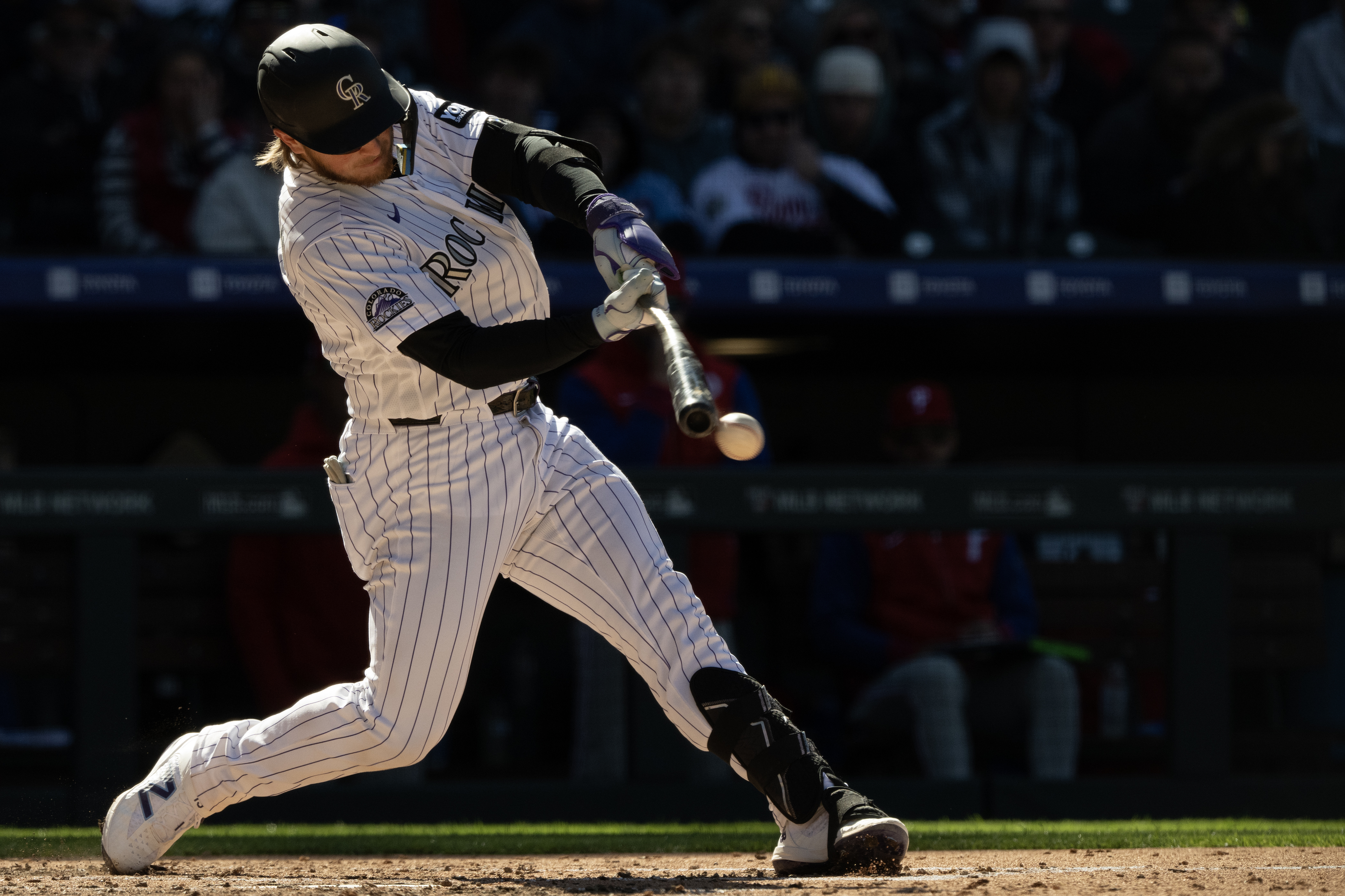 Catcher Hunter Goodman (15) of the Colorado Rockies makes contact...