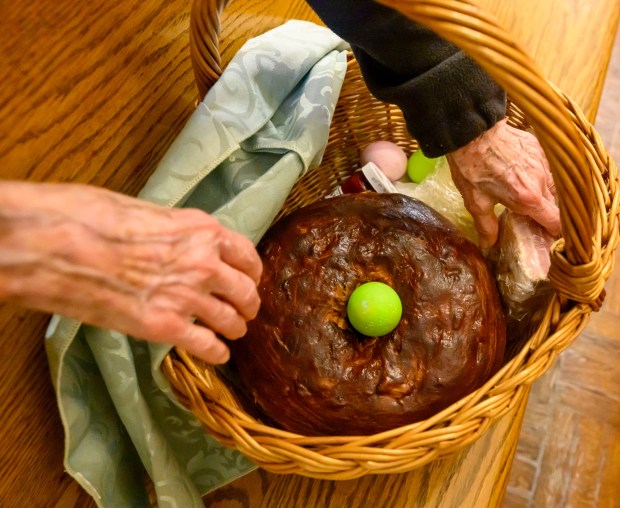 Mary Stofanak Rzucidlo, 92, of Bethlehem shows her Easter basket filled with food Saturday, April 4, 2026, to be blessed by Rev. Giuseppe Esposito on Holy Saturday at St. Anne Catholic Church in Bethlehem. Stofanak Rzucidlo has been getting her Easter baskets blessed since she was 8 years old. (April Gamiz/The Morning Call)