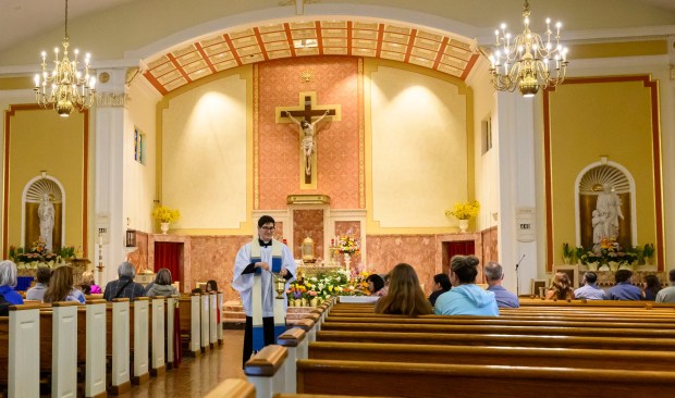 Rev. Giuseppe Esposito sprinkles holy water on prepared Easter baskets Saturday, April 4, 2026, during a blessing of the food baskets on Holy Saturday at St. Anne Catholic Church in Bethlehem. (April Gamiz/The Morning Call)