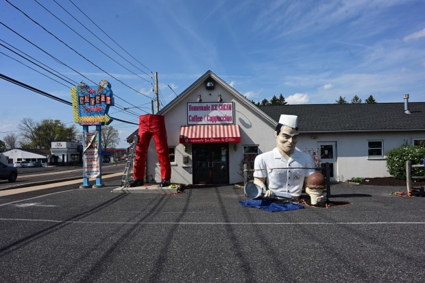 Roadside artist Mark Cline prepares the bottom half of the Giant Chip statue Thursday, April 16, 2026, at Inside Scoop in Coopersburg. The popular, 25-foot-high statue was toppled by high winds in February. Cline, who built the statue, was on site Thursday to repair it. (Monica Cabrera / The Morning Call)