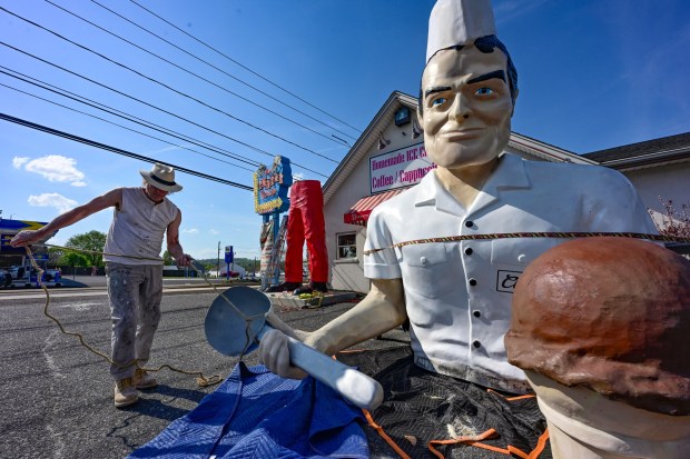Roadside artist Mark Cline prepares the top half of the Giant Chip statue Thursday, April 16, 2026, at Inside Scoop in Coopersburg. The popular, 25-foot-high statue was toppled by high winds in February. Cline, who built the statue, was on site Thursday to repair it. (Monica Cabrera / The Morning Call)