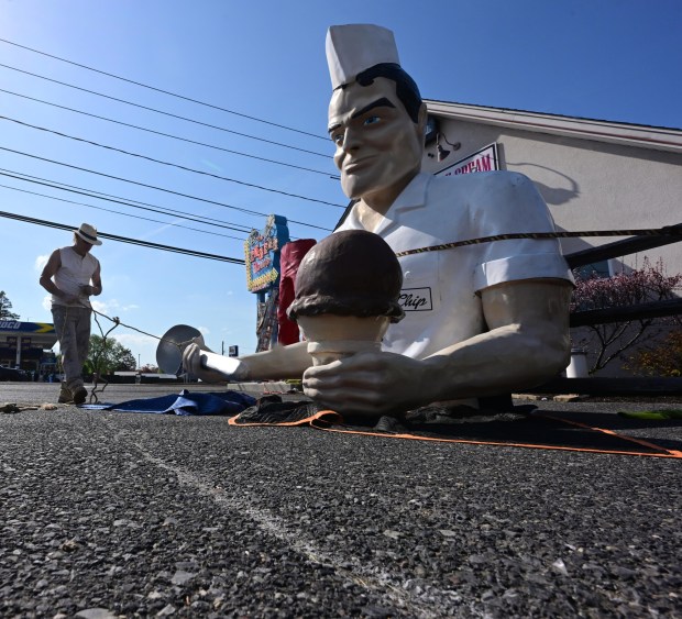 Roadside artist Mark Cline prepares the top half of the Giant Chip statue Thursday, April 16, 2026, at Inside Scoop in Coopersburg. The popular, 25-foot-high statue was toppled by high winds in February. Cline, who built the statue, was on site Thursday to repair it. (Monica Cabrera / The Morning Call)