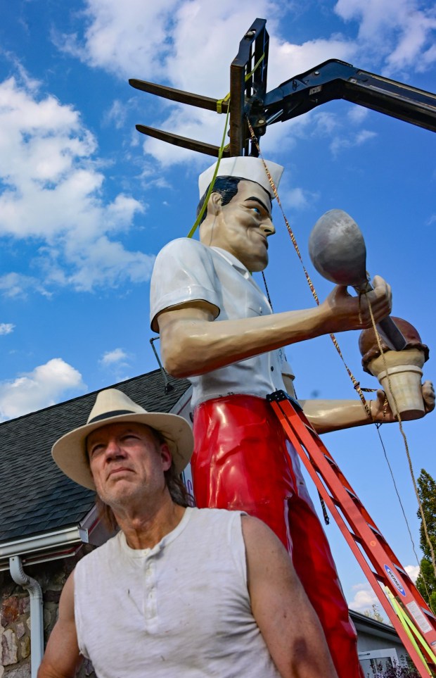 Roadside artist Mark Cline pieces the Giant Chip statue back together Thursday, April 16, 2026, at Inside Scoop in Coopersburg. The popular, 25-foot-high statue was toppled by high winds in February. Cline, who built the statue, was on site Thursday to repair it. (Monica Cabrera / The Morning Call)