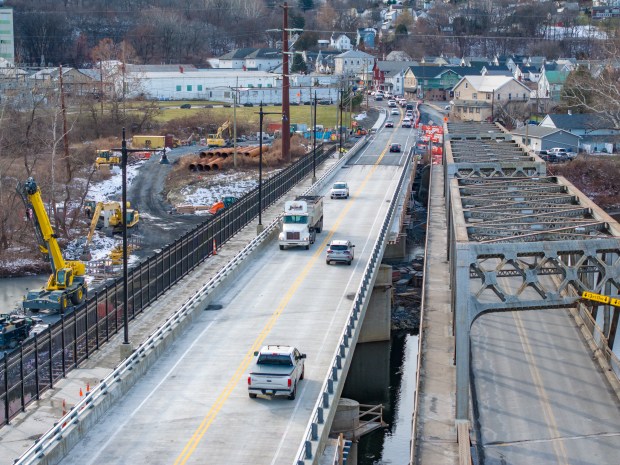 Motorists use the new Cementon Bridge over the Lehigh River between Northampton and Whitehall Township on Monday, Dec. 8, 2025. The 585-foot-long concrete span, which has been under construction since March 2023, opened to traffic Sunday, Dec. 7, 2025. The old bridge, right, still needs to be removed. (Scott M. Nagy/Special to The Morning Call)