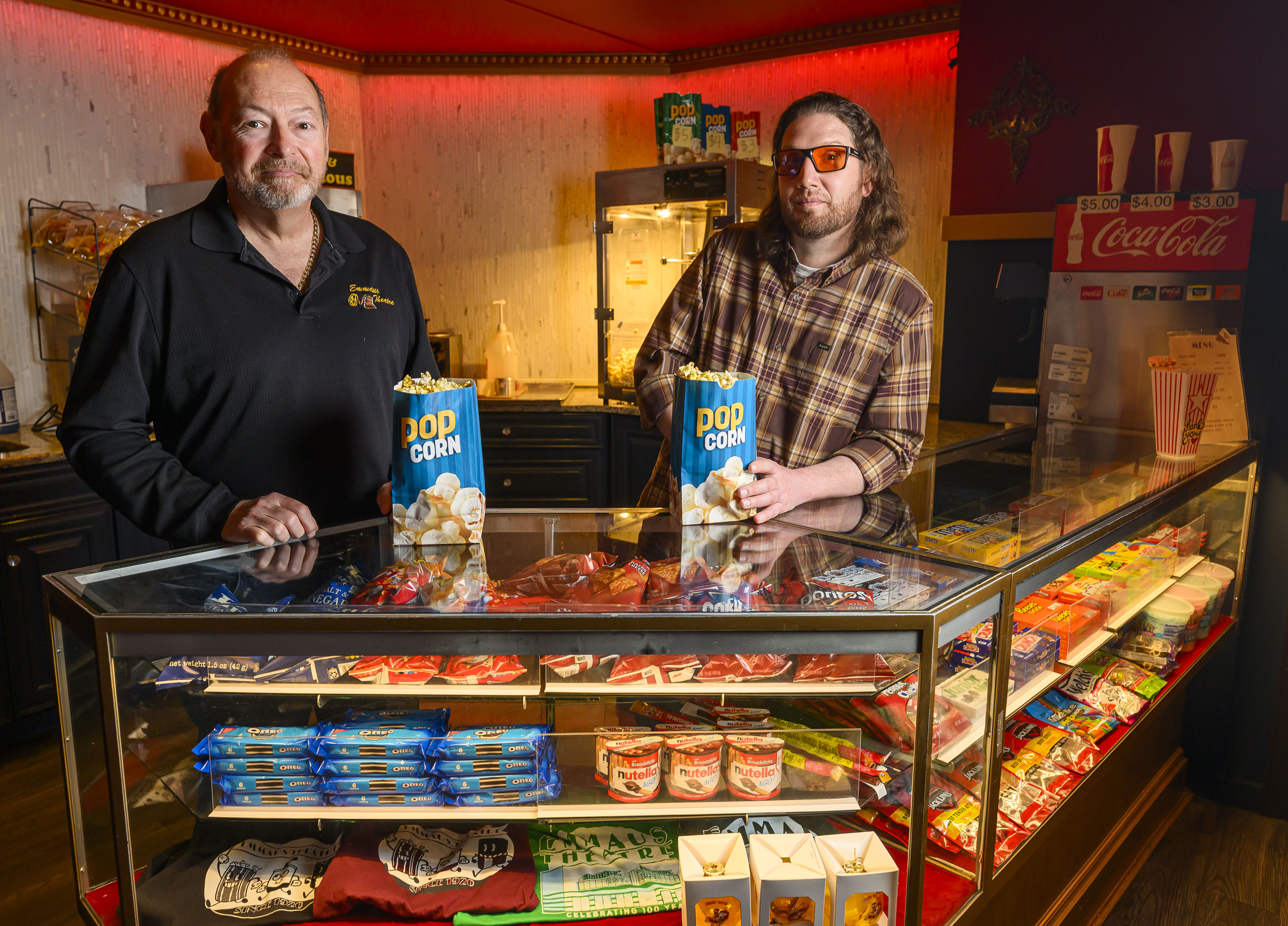 Emmaus Theatre owners Butch Rossetti and Robert Audibert stand behind...