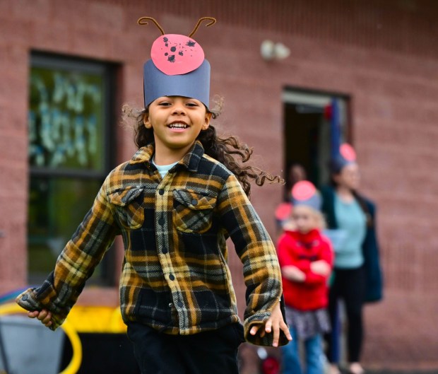 Preschooler Aella Montemayor bursts out of a classroom Wednesday, April 22, 2026, to release ladybugs as part of an Earth Day celebration Wednesday, April 22, 2026, at Chesterbrook Academy in Bethlehem Township. Students released 2,000 beneficial ladybugs into their schoolyard to protect the environment and local vegetation for Earth Day at Chesterbrook Academy in Bethlehem. (Monica Cabrera/The Morning Call)