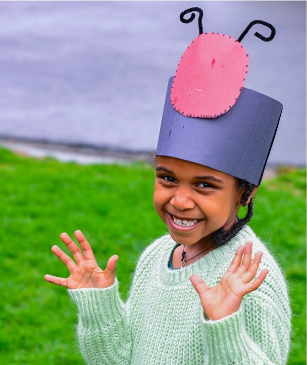 Wearing a ladybug hat she made, preschooler Eliana Solomon-Eshetie releases ladybugs Wednesday, April 22, 2026, at Chesterbrook Academy in Bethlehem Township. Students released 2,000 beneficial ladybugs into their schoolyard to protect the environment and local vegetation for Earth Day at Chesterbrook Academy in Bethlehem. (Monica Cabrera/The Morning Call)