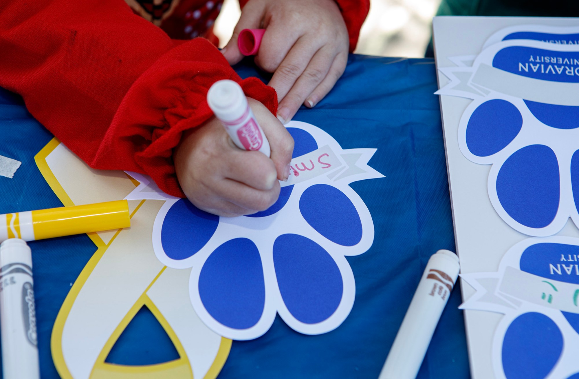 Ryleigh Smith, 5, of Bethlehem writes her family's name on a paw print during Pawapalooza on Saturday, April 11, 2026, at Moravian University's Priscilla Payne Hurd Academic Complex in Bethlehem. The event supports the Pawprint Project, a student-led organization raising money for the Pediatric Cancer Foundation of the Lehigh Valley. It features live music, games and other activities.(Jane Therese/Special to The Morning Call)