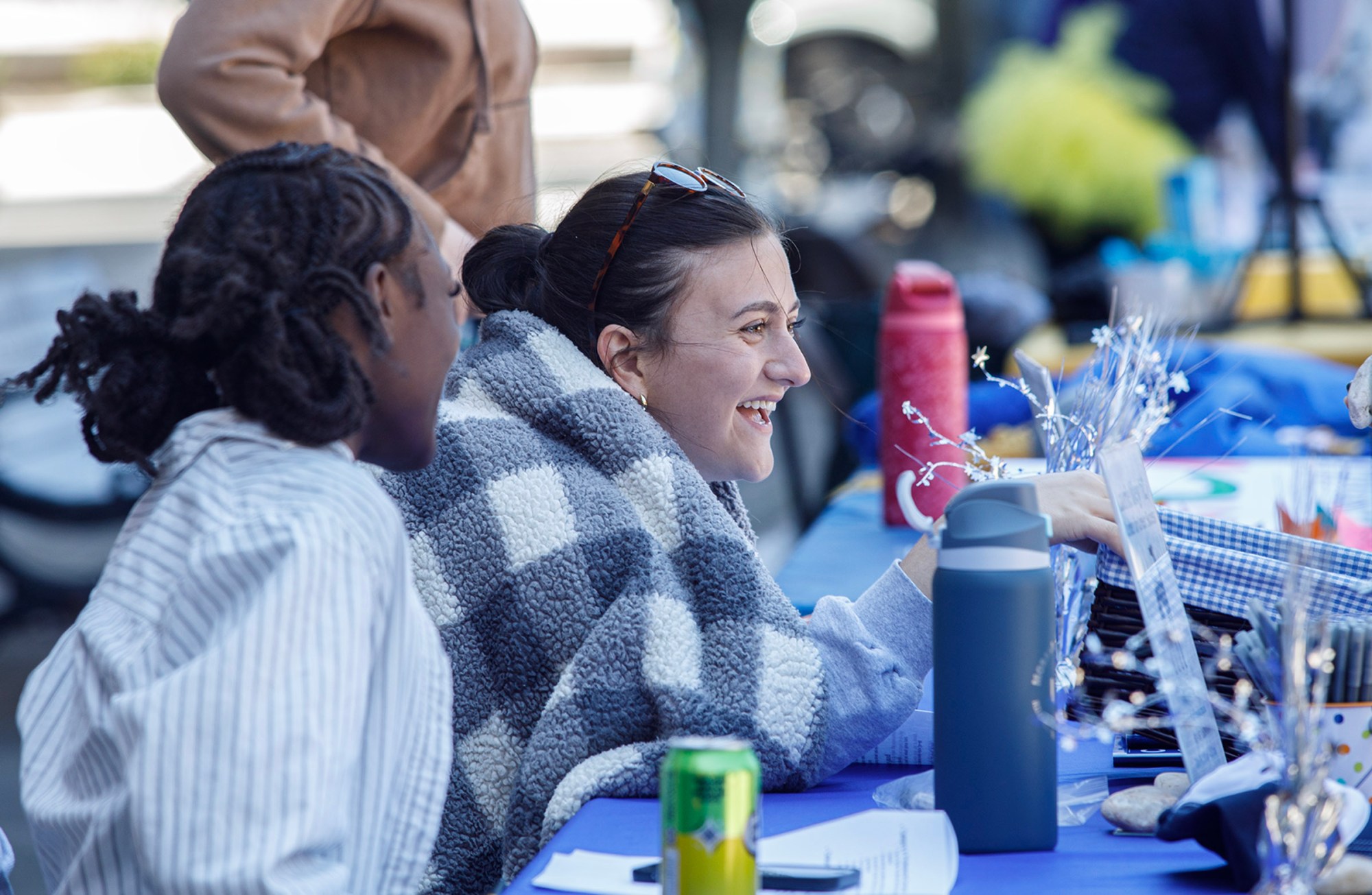 Hanna Nowak, a Moravian University senior from Allentown, works the Laurie Riley table during Pawapalooza on Saturday, April 11, 2026, at Moravian University's Priscilla Payne Hurd Academic Complex in Bethlehem. The event supports the Pawprint Project, a student-led organization raising money for the Pediatric Cancer Foundation of the Lehigh Valley. It features live music, games and other activities.(Jane Therese/Special to The Morning Call)