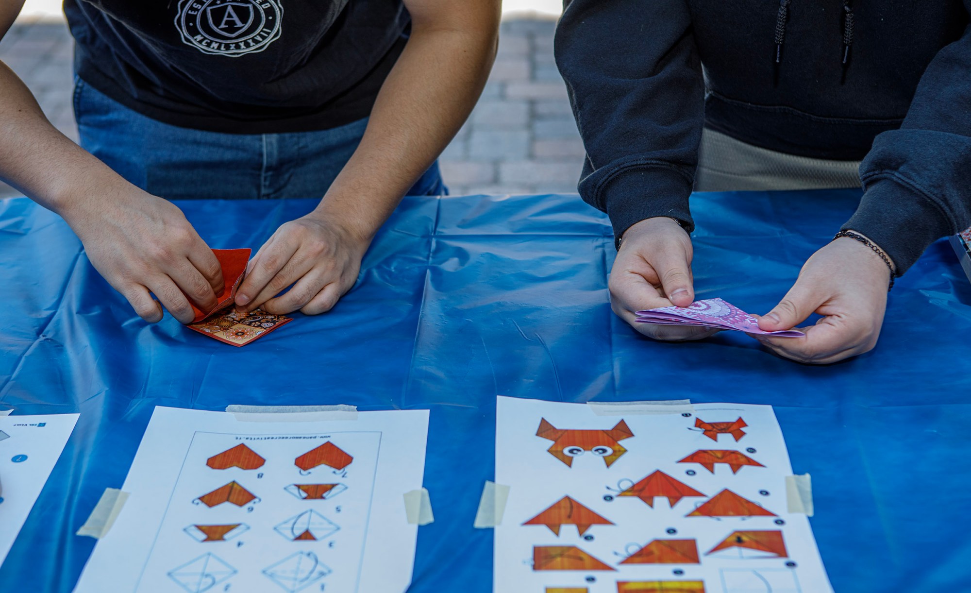 Victor Rivera, a Moravian University senior of Forks Township and Austyn Bunker a Moravian University freshman of Effort, make origami during Pawapalooza on Saturday, April 11, 2026, at Moravian University's Priscilla Payne Hurd Academic Complex in Bethlehem. The event supports the Pawprint Project, a student-led organization raising money for the Pediatric Cancer Foundation of the Lehigh Valley. It features live music, games and other activities.(Jane Therese/Special to The Morning Call)