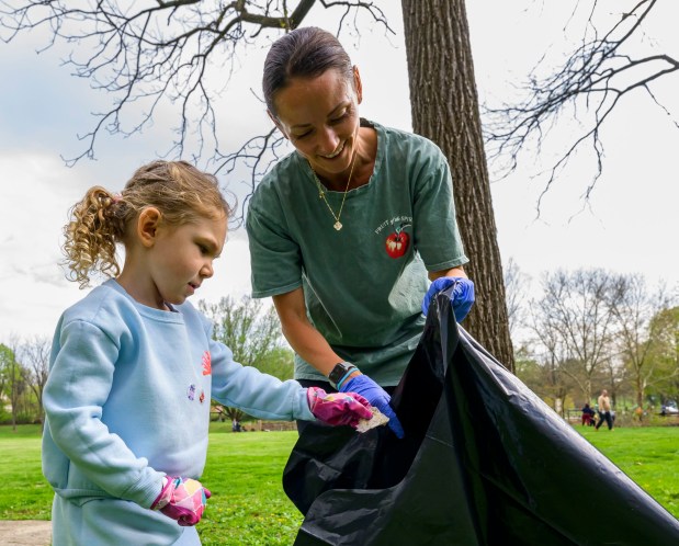Mother Brittany Waterhouse and daughter Grace, 5, both of Schnecksville pick up litter along the park Wednesday, April 22, 2026, in celebration of Earth Day during Plant for Spring! hosted by South Whitehall Township Parks and Recreation at Covered Bridge Park Playground in South Whitehall Township (April Gamiz/The Morning Call)